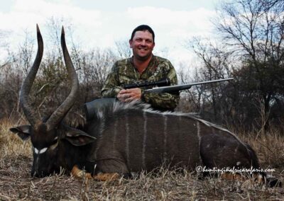 A smiling Australian hunter posing with a trophy Nyala Tragelaphus angasii bull in the Thabazimbi region.