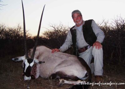 An elderly hunter posing with a trophy Gemsbok Oryx gazella cow in the Limpopo Province.