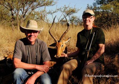 A hunter and his wife posing with an Impala Aepyceros melampus in the Springbok Flats bushveld.